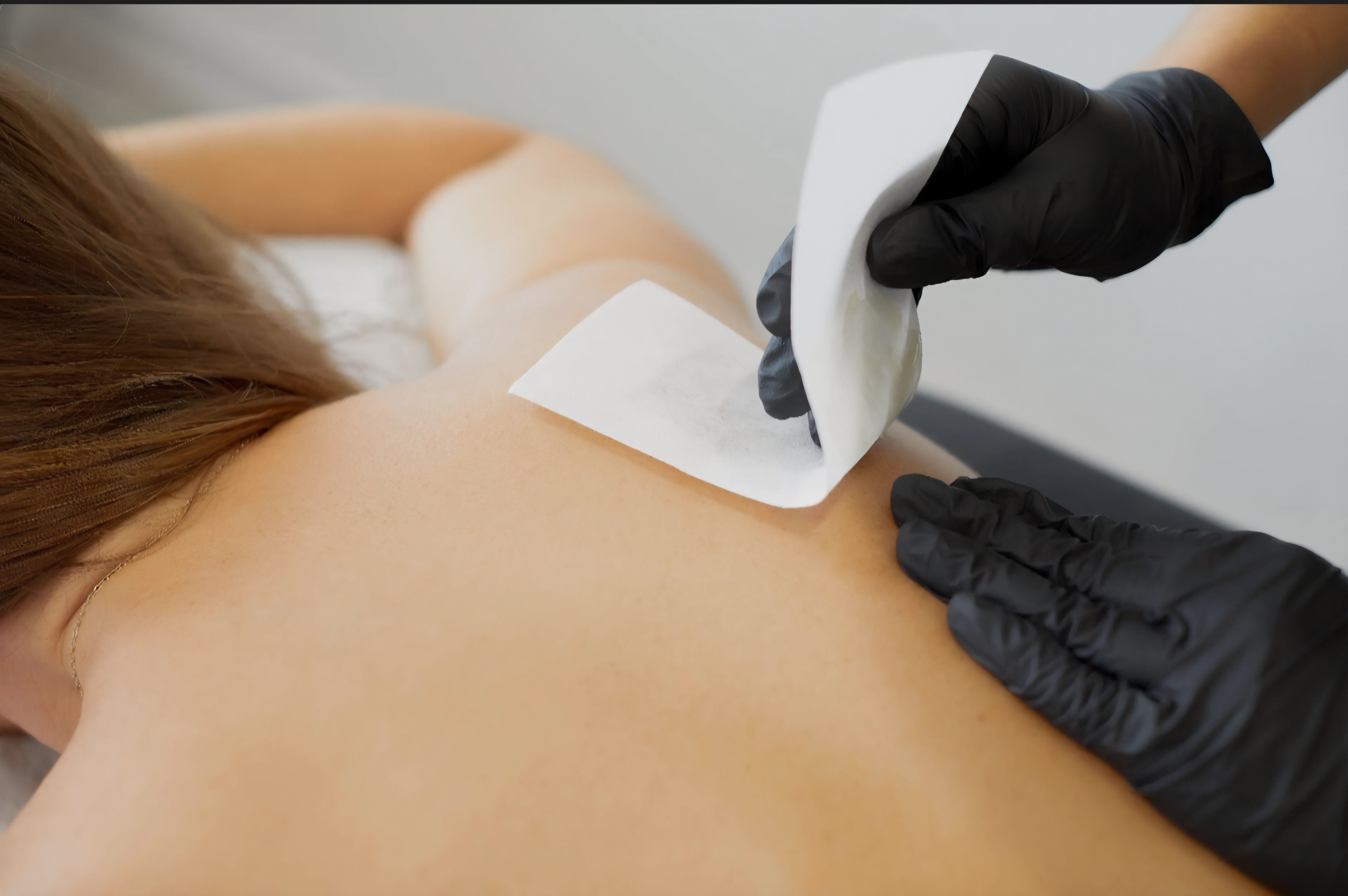 Back woman waxing